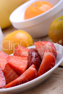 Fresh colorful fruits composition mandarin, strawberry, peach, bananas and orange