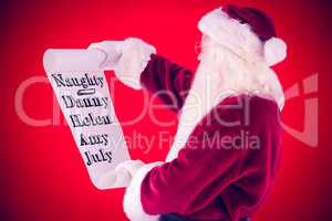 Composite image of santa claus reads a list