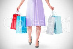 Mid section of woman holding shopping bags