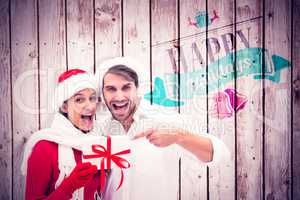 Composite image of festive young couple holding gift