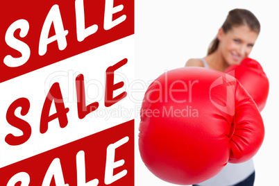 Composite image of portrait of a smiling woman boxing