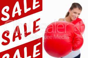 Composite image of portrait of a smiling woman boxing