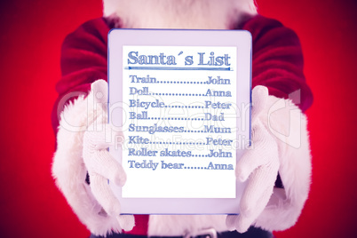 Composite image of santa presents a tablet pc