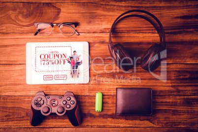 Composite image of tablet and glasses next to joystick music hea