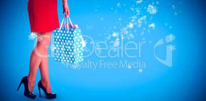 Composite image of woman standing with shopping bags