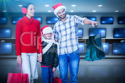 Composite image of happy family looking at camera