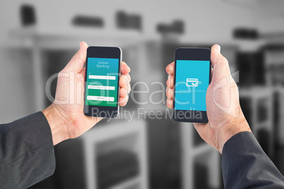 Composite image of businessman holding two smart phones