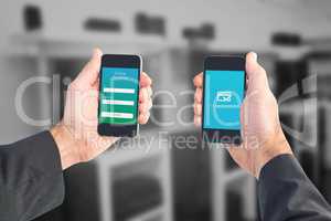 Composite image of businessman holding two smart phones