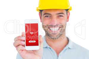 Composite image of portrait of smiling handyman showing smart ph