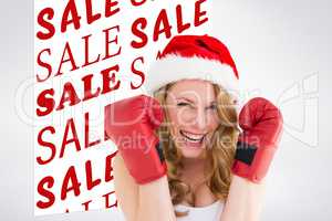 Composite image of blonde woman wearing boxing gloves smiling at