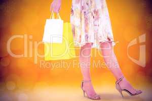 Composite image of elegant woman with shopping bags