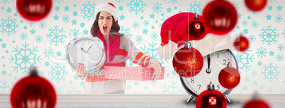 Composite image of surprised brunette holding a clock and gift