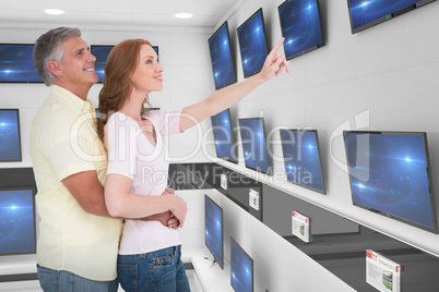 Composite image of casual couple hugging and looking