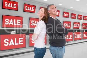 Composite image of casual couple smiling and looking up