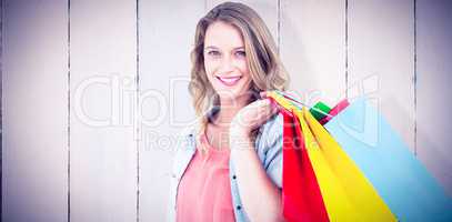 Composite image of woman holding some shopping bags