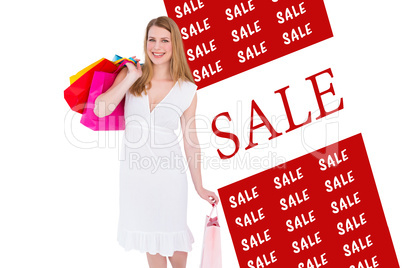 Composite image of happy blonde holding shopping bags in white d