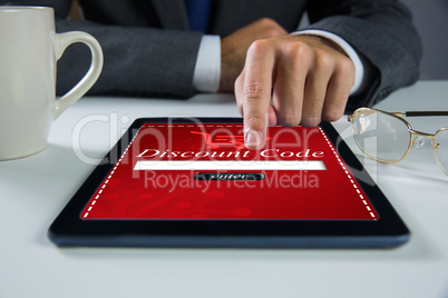 Composite image of businessman using digital tablet