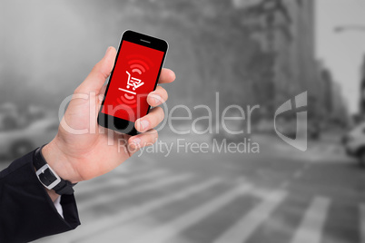 Composite image of cropped hand holding mobile phone