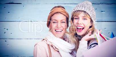 Composite image of smiling women looking at camera with shopping