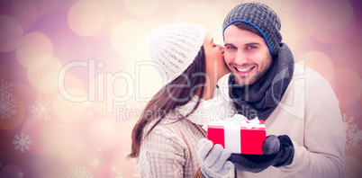 Composite image of winter couple holding gift