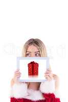 Composite image of pretty santa girl holding tablet