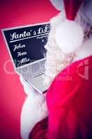 Composite image of santa claus using his laptop