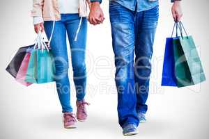 Couple with shopping bags holding hands
