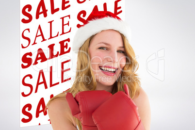 Composite image of smiling blonde wearing red boxing gloves