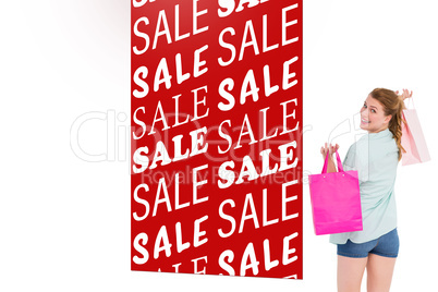 Composite image of woman carrying shopping bags over her shoulde