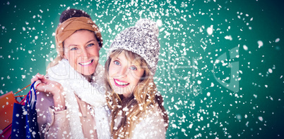 Composite image of beautiful women holding shopping bags looking