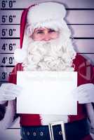 Composite image of cheerful santa claus holding page