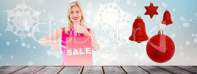 Composite image of stylish blonde in red dress showing sale bag