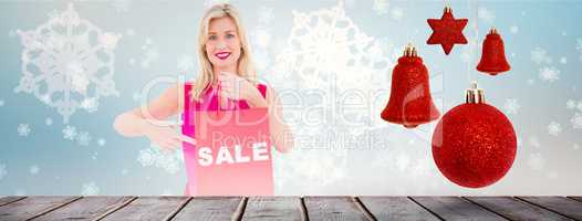Composite image of stylish blonde in red dress showing sale bag