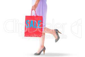 Composite image of mid section of woman holding red shopping bag