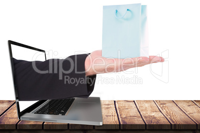 Composite image of businessman holding hand out in presentation