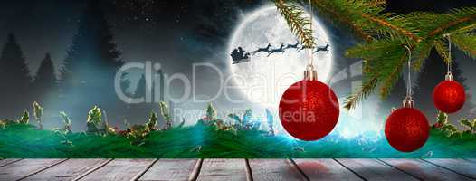 Composite image of baubles on tree