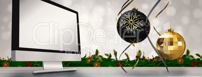 Composite image of hanging christmas bauble decorations