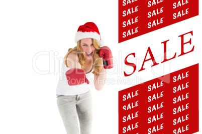 Composite image of festive blonde punching with boxing gloves