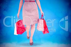 Composite image of elegant brunette with shopping bags