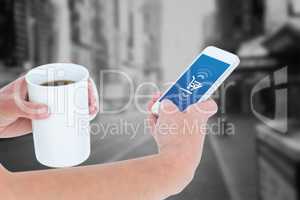 Composite image of woman using smartphone while holding coffee