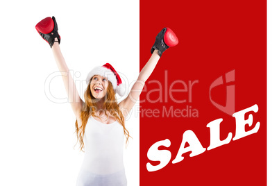 Composite image of festive redhead cheeering with boxing gloves