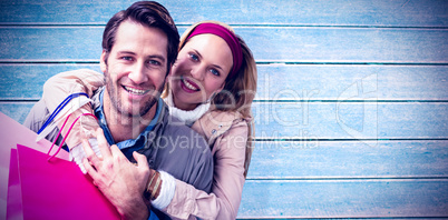 Composite image of smiling couple embracing