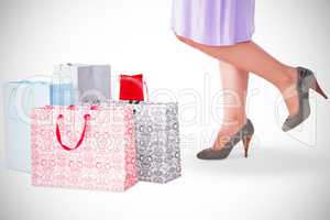 Mid section of woman with shopping bags