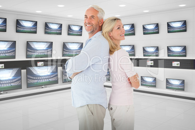Composite image of happy couple standing with each other