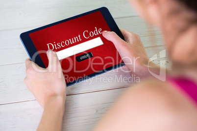 Composite image of woman using tablet at home