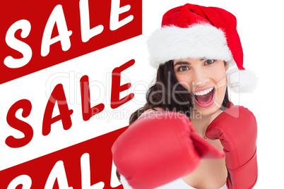 Composite image of festive brunette in boxing gloves punching