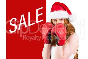 Composite image of festive redhead with boxing gloves
