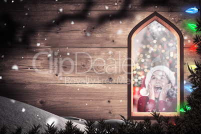 Composite image of festive little girl looking surprised