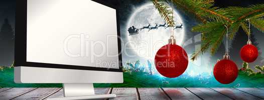 Composite image of baubles on tree