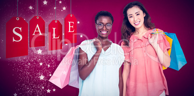 Composite image of female friends holding shopping bags